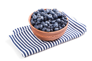 Bowl of ripe blueberries isolated on white