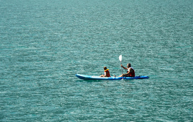father and son at kayak in Molveno lake in Italy