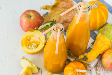 Apple and pumpkin smoothie in glass bottles