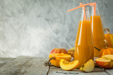 Apple and pumpkin smoothie in glass bottles