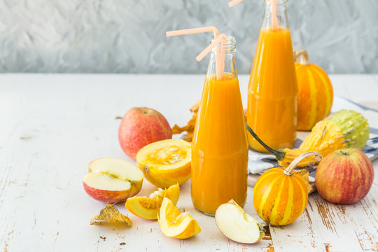 Apple and pumpkin smoothie in glass bottles