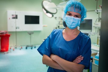 Fototapeta na wymiar Portrait of a female surgeon standing in operation room