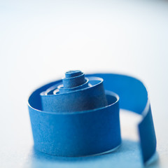 Macro, abstract, background picture of blue paper spirals on paper background
