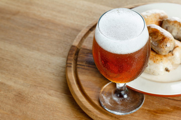 Traditional homemade sausage with beer on wooden table