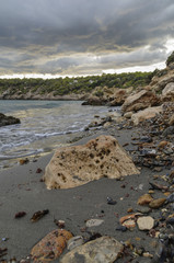 coast with stones is washed by mediterranean sea.Ibiza,Spain
