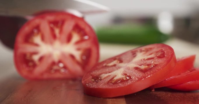 teenage girl slicing tomato 60 fps slow motion