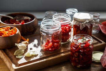 Sun dried tomatoes with herbs and sea salt in olive oil in a glass jar