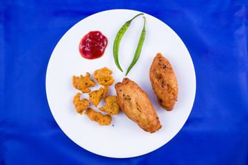 Indian food - bread roll with fish stuffing and veg pakora