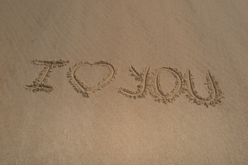 I love you, valentines day written on the sand