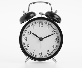 Black alarm clock isolated on white background