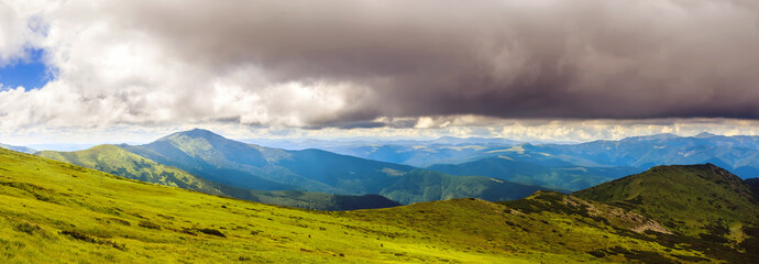 Picturesque Carpathian mountains landscape in summer, wide angle panoramic view, Ukraine.