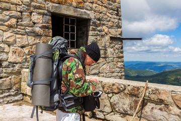 Portrait of young men tourist in the old observatory on top of Pip Ivan mountain, Carpathians,...