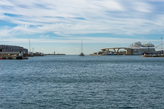Sailboat leaves the marina Port Vell and is going to deep sea. The harbor in Barcelona is popular and an important destination for sailing trips