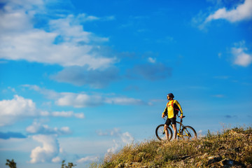 young bright man on mountain bike