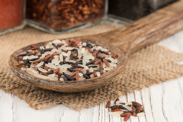 Mix the rice in a wooden spoon ins old wooden table.