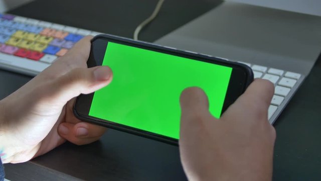 Man Writing A Message On His Smartphone In Landscape Mode, Green Screen

