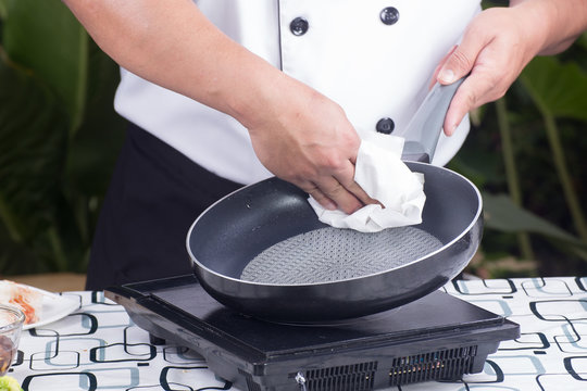 chef wiping the pan before cooking