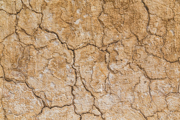 Cracked light beige coloured background texture