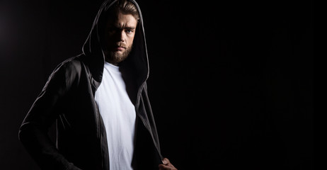 Baerded man in white t-shirt on black background