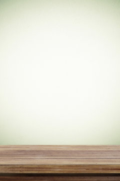 Empty wooden table over cement wall  background