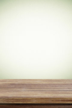 Empty wooden table over cement wall  background
