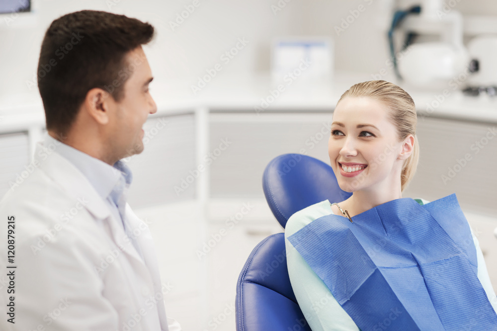 Sticker happy male dentist with woman patient at clinic