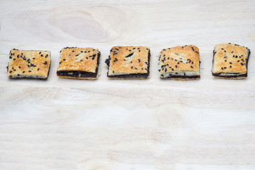 black sesame mini pie placed on wood