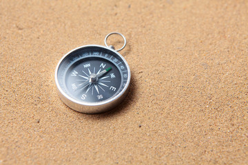 Compass on the sea sand