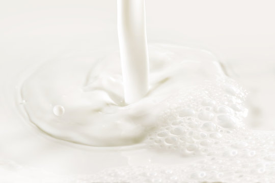 close up of poured fresh milk and bubbles