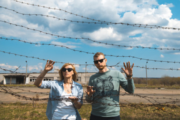 мужчина и женщина за колючей проволокой