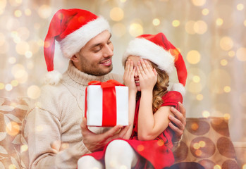 smiling daughter waiting for a present from father
