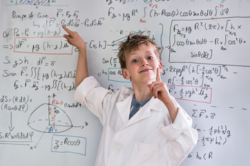 Fototapeta premium young funny genius posing in front of a board wiht math calculs