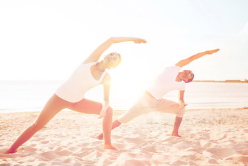 couple making yoga exercises outdoors