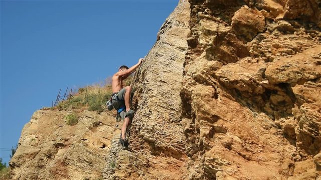 Extreme Climber Climbing A Rope From A Cliff