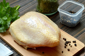 Raw chicken breast with skin