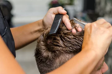 Küchenrückwand glas motiv Friseur men's hair cutting scissors in a beauty salon
