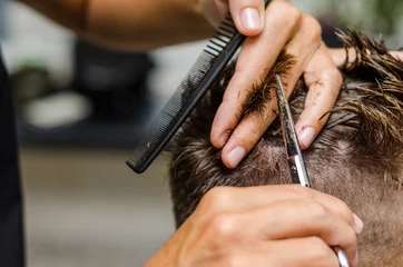 Door stickers Hairdressers men's hair cutting scissors in a beauty salon