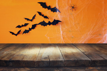 Empty rustic table in front of spider web background