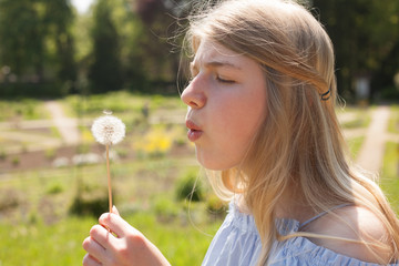 Blowing on a dandelion