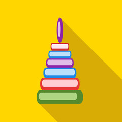 Children's toy pyramid on a yellow background