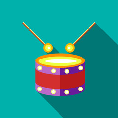 Children's toy drum on blue-green background