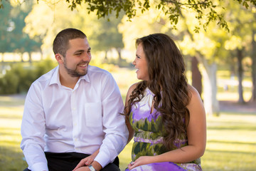 Young pregnant couple in a nice park. Maternity. Family