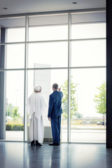 Manager with Arabian partner look outdoor