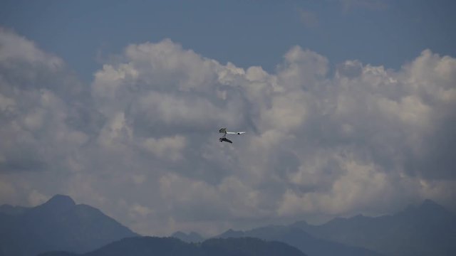 Rigid wing hang glider flying among the clouds