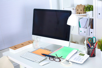 Designer working desk with computer and paperwork