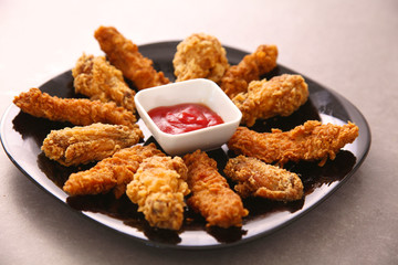 Grilled chicken on a plate standing the wooden table