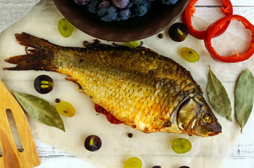 Baked fish carp, stuffed bell peppers and grapes.