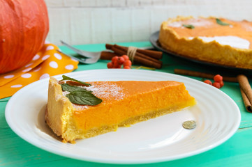 Sweet pumpkin pie. A piece on a white plate. Dietary vegan dish. Traditional baked for Thanksgiving.