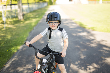 six year old boy biking in the park