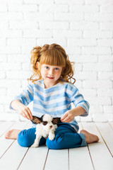 Redhead girl with a cocker spaniel puppy